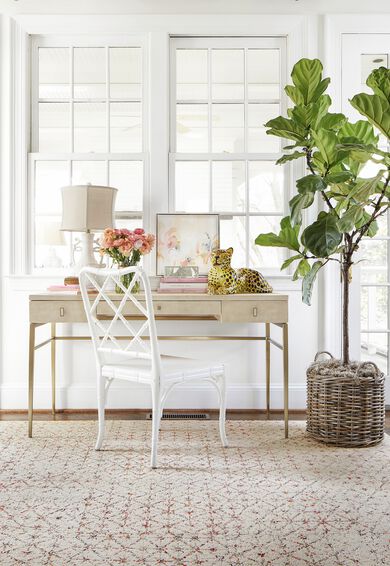 Home office with orange and peach flowers featuring FLOR Vintage Vibe area rug shown in Coral