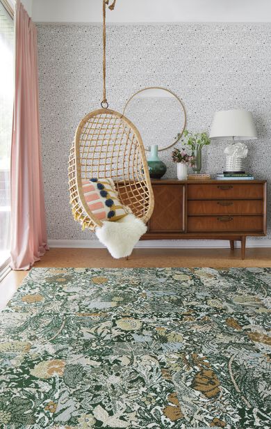 Bedroom nook with FLOR Among The Wildflowers area rug shown in Ivy