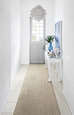 White and light-filled foyer with runner made of Suit Yourself in Flax.