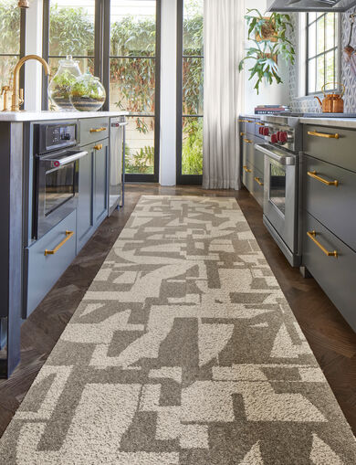 Bright and moody kitchen with FLOR Modern Maze runner rug shown in Dune