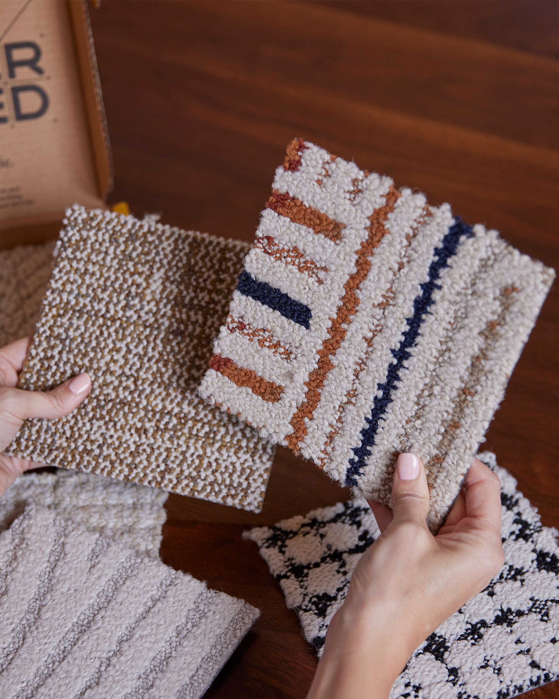 Hands holding FLOR Carpet Tile Samples