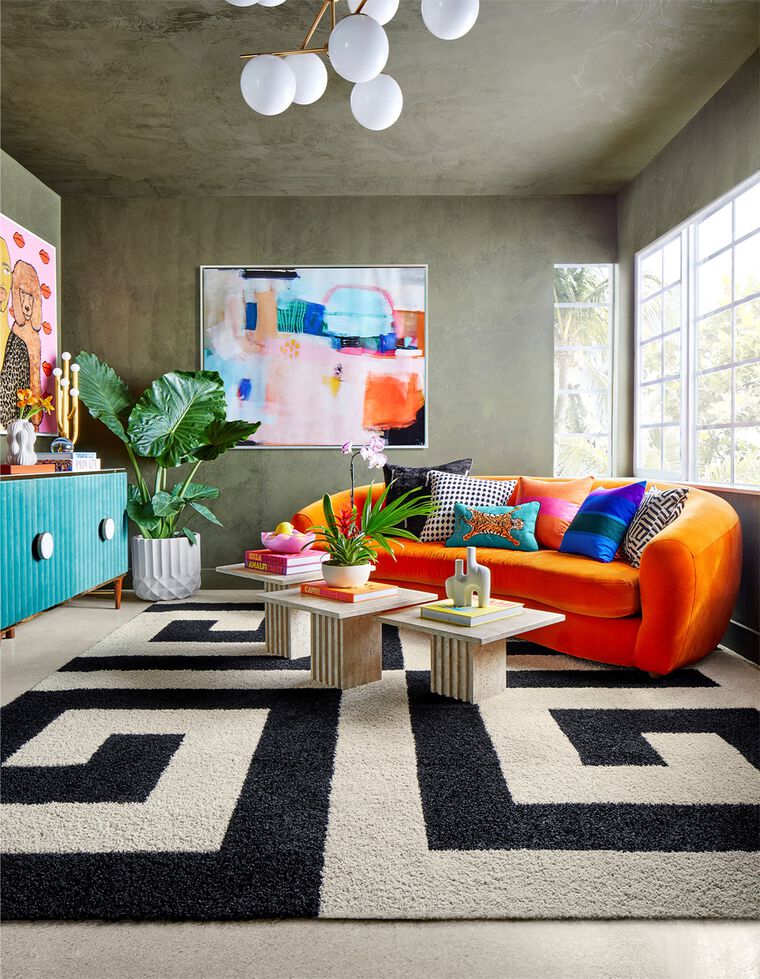 Industrial style loft with bright orange decor featuring FLOR Signature Rug All The Right Angles