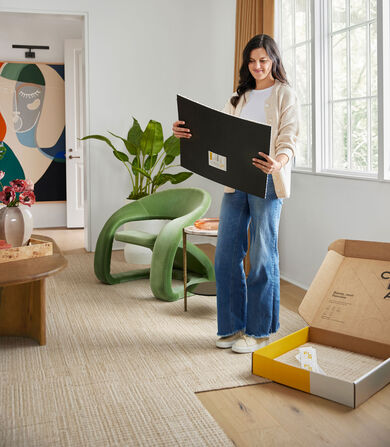 Living room with FLOR tiles being assembled out of the box