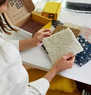 Detail shot of Jewel Marlowe sorting through FLOR carpet tile samples