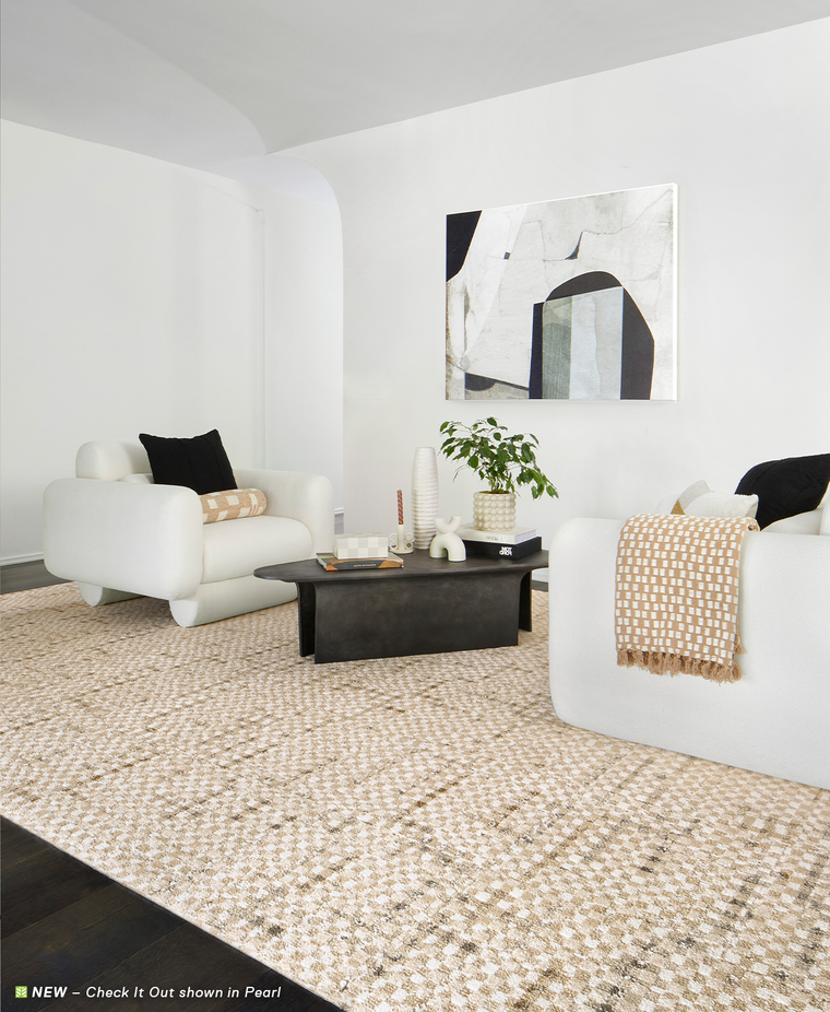 White chairs and black coffee table on FLOR Check It Out shown in Pearl