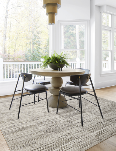 Dining room with FLOR Fully Barked area rug shown in Pigeon