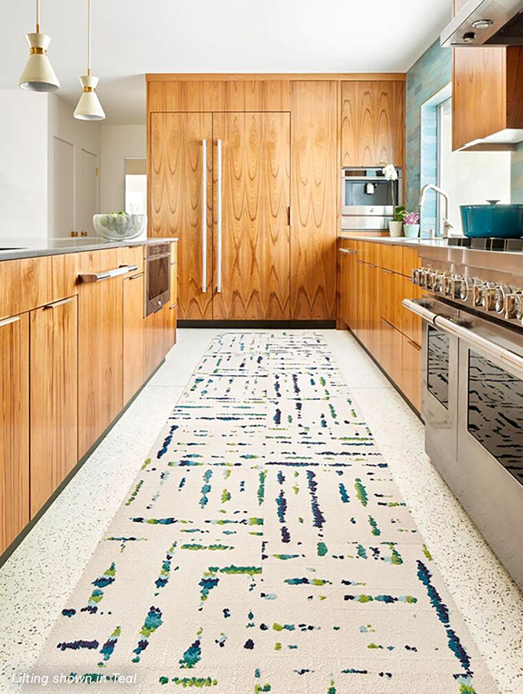 Warm kitchen with wood cabinetry and FLOR Lilting runner shown in Teal