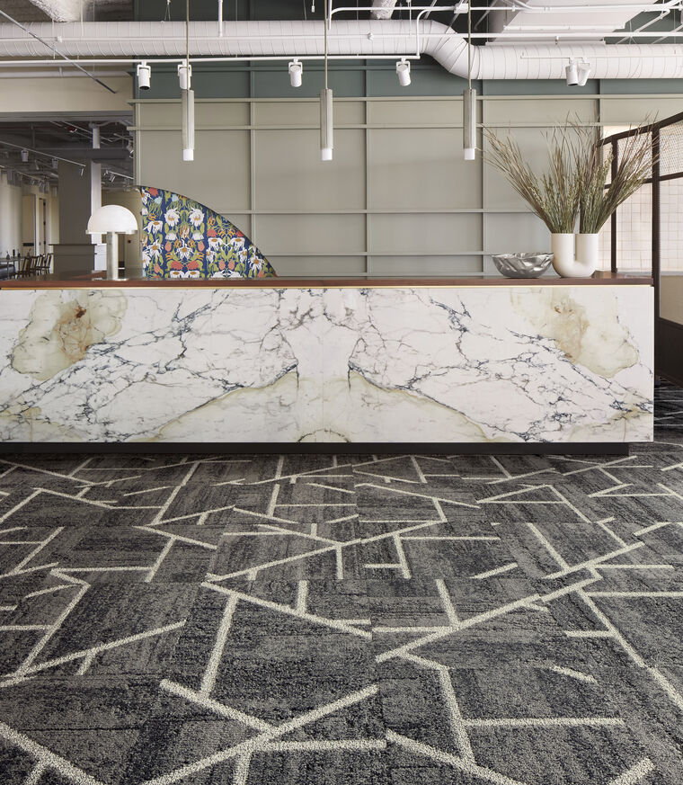 Lobby area with FLOR area rug Heavy Metal shown in Titanium/Silver