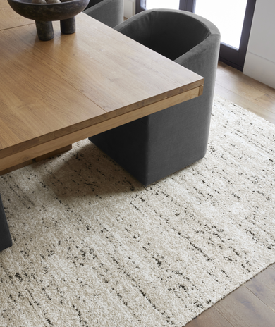 Table with FLOR Tivoli Touch area rug shown in Bone