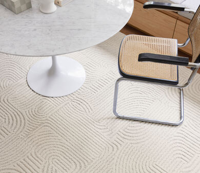 Chair and table with FLOR Curves You Right area rug shown in Bone