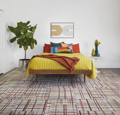 Bedroom with FLOR Savile Row area rug shown in Berry