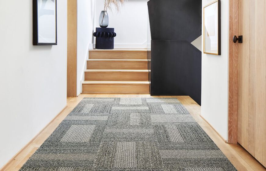 FLOR Ticket To Ride rug runner in a modern hallway shown in Flint/Pearl