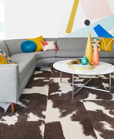 Seating area with FLOR Mod Cow area rug shown in Brown