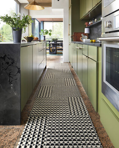 Kitchen aisle with FLOR area rug Good Company shown in Black