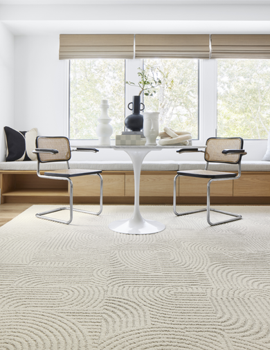 Dining Table with FLOR Curves You Right area rug shown in Bone