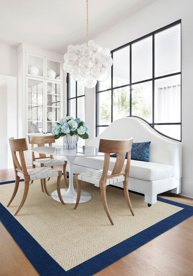 Dining area with FLOR Suit Yourself with Quarter Border shown in Flax and Cobalt