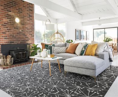 Living room with white walls, shown on FLOR Mod Cafe area rug shown in Black