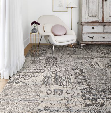 Corner sitting nook with FLOR Reoriented area rug shown in Grey