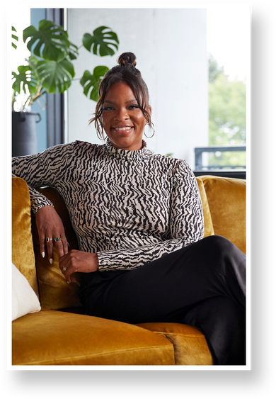 Candace Griffin portrait sitting on a velvet gold couch