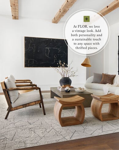 Wood-accented living room with FLOR Chasing Pavement area rug shown in Chalk/Silver