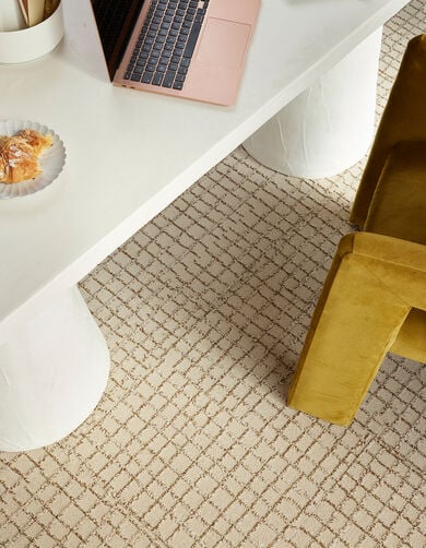Detail view of home office desk with FLOR Squared Away area rug shown in Pearl/Topaz