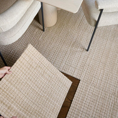 FLOR carpet tile installation with hand holding a tile