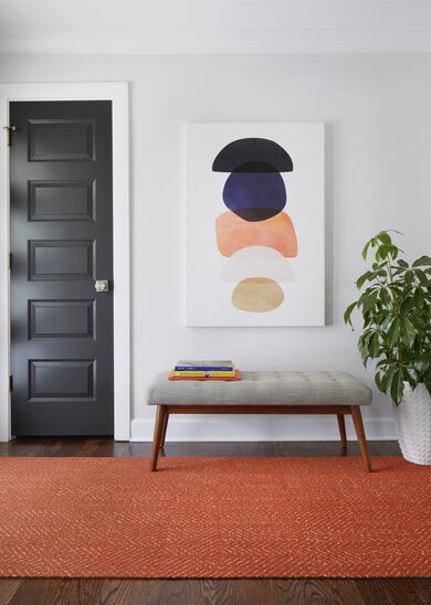 Foyer area with FLOR Open Invitation area rug shown in Orange with bench seating