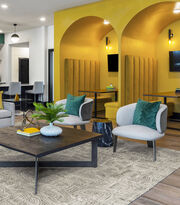 Detail of seating area and yellow work booths with FLOR area rug Anthracite shown in Chalk/Silver