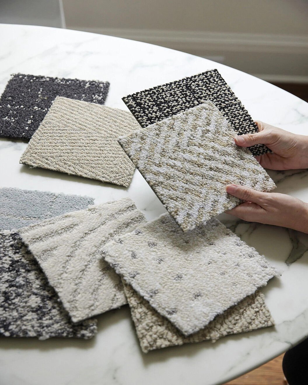 Hands holding FLOR Carpet Tile Samples