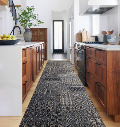 Kitchen aisle with FLOR Oasis Retreat area rug shown in Granite