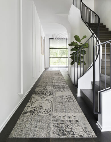 Hallway with FLOR Reoriented area rug shown in Grey.