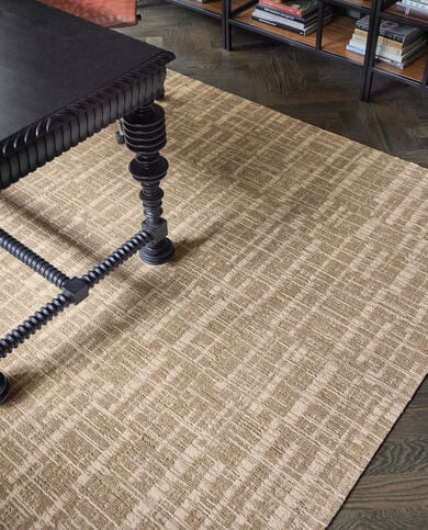 Coffee table with FLOR Crossed Signals area rug shown in Fawn/Tundra