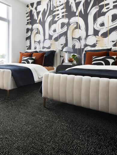 Graphic wallpapered bedroom with FLOR Hemline area rug shown in Flint