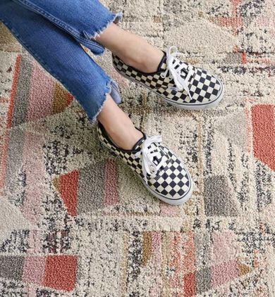 Detail shot showing feet on top of NEW –FLOR High Hopes area rug in Blush