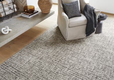 Living room area with FLOR Tailored Touch area rug shown in Natural