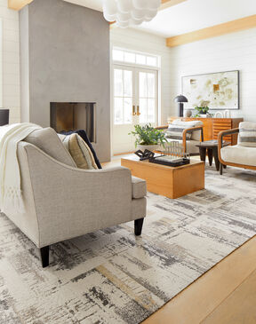 Seating area next to fireplace featuring FLOR Splish Splash area rug shown in Eggnog.
