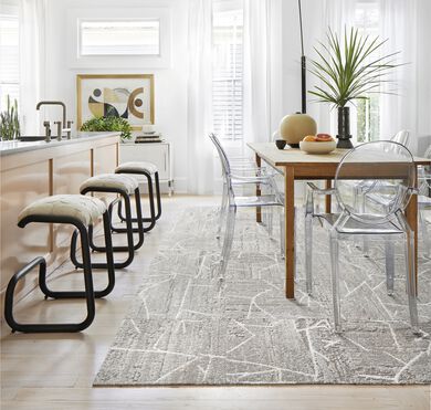 Dining room with FLOR Terrain area rug shown in Chalk with peach bar seating