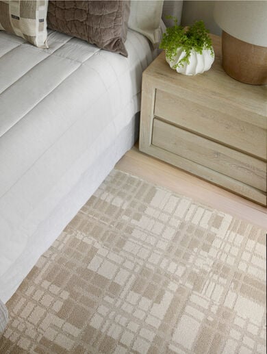 Detail view of bedroom with FLOR Plaid And Simple area rug shown in Bone/Tundra