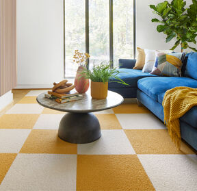 Warm and clean living room with FLOR Heaven Sent area rug in Marigold and Bone