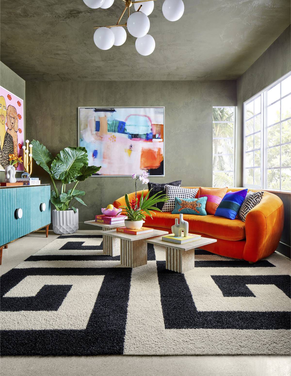 Photo of Travis London's living room with bright orange couch and NEW FLOR Signature Rug All The Right Angles