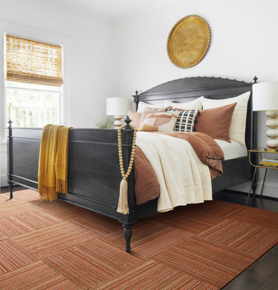 Bedroom with FLOR Upcycle area rug shown in Orange