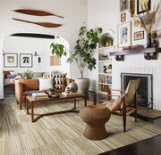 Warm living room with wood accents and FLOR area rug Hemisphere shown in Tan.