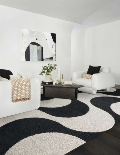 Modern living room with white and black decor featuring FLOR Signature Rug In Limbo