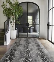 Contemporary entry area with iron windows and potted tree featuring FLOR Doe Re Mi runner shown in Black