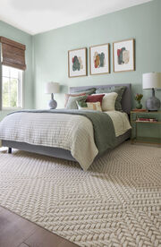 Warm living room with wood accents and FLOR area rug Hemisphere shown in Tan.