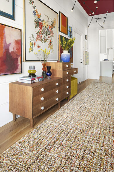 Living room wall with FLOR Tailored Touch area rug shown in Clementine